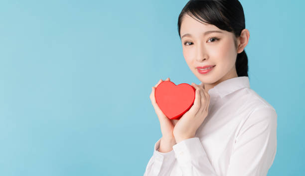 istock Asian woman holding a heart shape box. 1272025141
