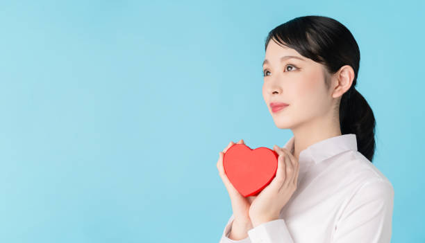 istock Asian woman holding a heart shape box. 1272025265