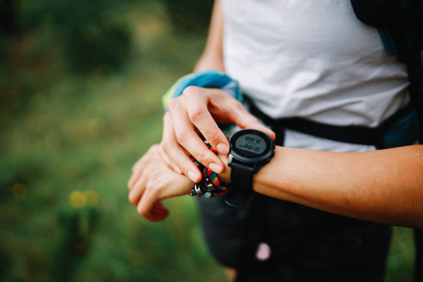 istock Young woman using a smart watch during the hiking trip 1272026814