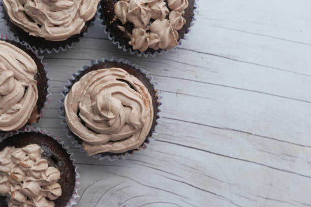 Top view of chocolate cup cake on wooden table