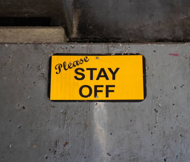 istock Please Stay Off Yellow Sign 1272030169