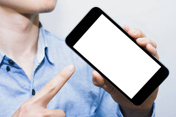 istock Asian businessman holding a smart phone showing an empty white screen mockup template on white background 1272035326