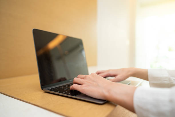 istock Woman working on laptop computer on wooden table. for your advertising text message. 1272036247