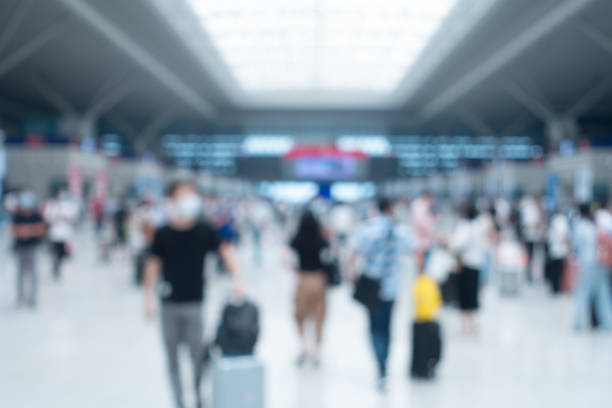 istock Defocused people walking in modern airport hallway 1272039135