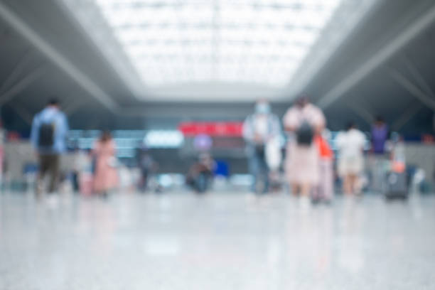 istock Defocused people walking in modern airport hallway 1272039166