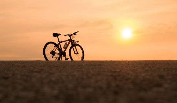 istock bicycle with sunset or sunrise background 1272039411