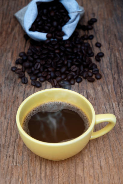 istock coffee cup and coffee beans on wood background. 1272039434