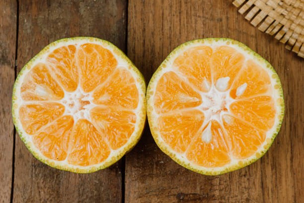 istock orange on the wooden table 1272039523