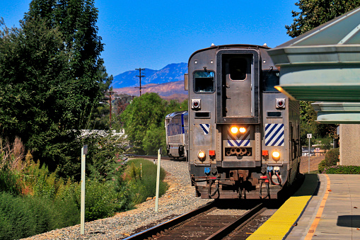 Kamloops, Canada - April 1, 2023: Freight trains wait near Riverside Park in the north end of downtown Kamloops. The West End neighbourhood includes hillside homes with views of the Thompson-Nicola Regional District. Spring morning with overcast skies.