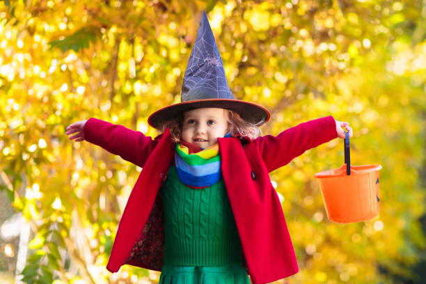 istock Kids trick or treat on Halloween night. 1272048304