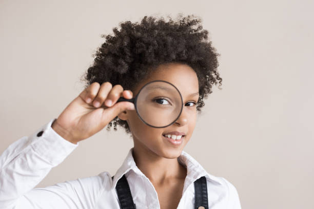 istock Little girl looking through magnifying glass 1272049384