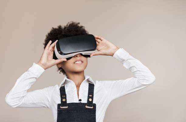 Little girl using virtual reality headset Teenage girl wearing VR headset. Virtual reality, future, gadgets, technology, education online, studying concept digital native stock pictures, royalty-free photos & images