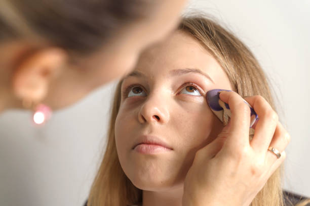 istock work of a makeup artist. young girl makeup process 1272050507