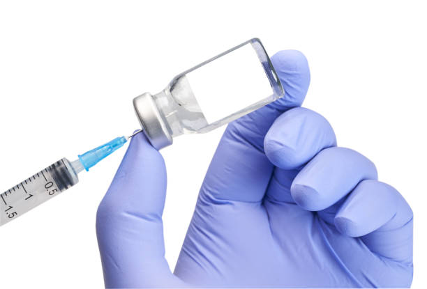 istock Hand holding multi-dose, injection vial and  syringe with blank label - white background, surgical glove 1272051302