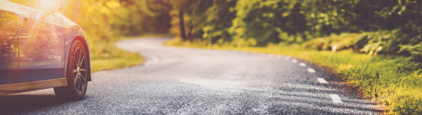 istock Blue car on asphalt road in summer 1272056578