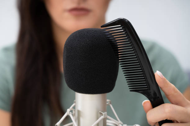 istock Woman Using Comb On Microphone To Make Asmr Sounds 1272058520