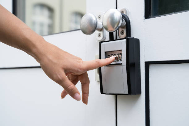 istock Woman Using Key Safe To Retrieve Keys 1272058532
