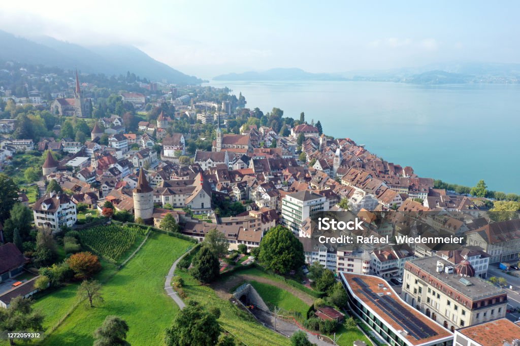 Train Panorama Zug panoramic view over the medieval old town and the beautiful Lake Zug. The wide angle image was captured during summer season. Zug - City Stock Photo