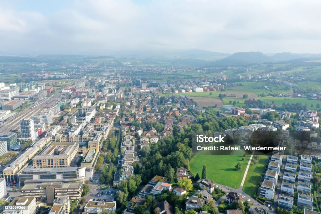 Baar Baar is a rapid growing town next to Zug City. Many national and international corporations in the finance and medical sector have their headquarters in Baar. The wide angle image was captured during summer season. Architecture Stock Photo