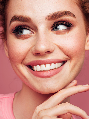 Close-up portrait of smiling girl with beautiful make-up