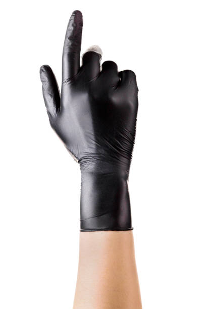 istock Hand in black gloves with the index finger pointing up on black 1272063848