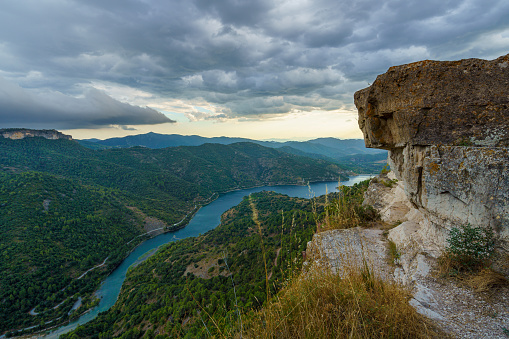 View of cliff and river flowing below near Siurana village in the province of Tarragona, Spain.