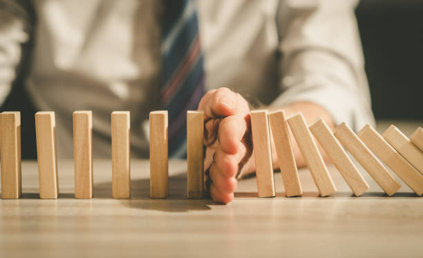 istock Concept of business control by stopping domino effect 1272065071