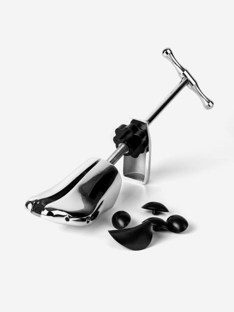 Spacer for stretching shoes on a white background Spacer for stretching shoes on a white background. Equipment for stretching of shoes. shoe mold stock pictures, royalty-free photos & images