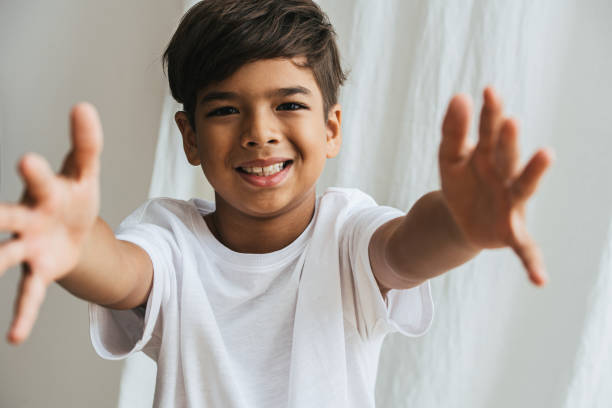 istock Friendly indian asian kid with arms outstretched, wanting to hug. 1272065928