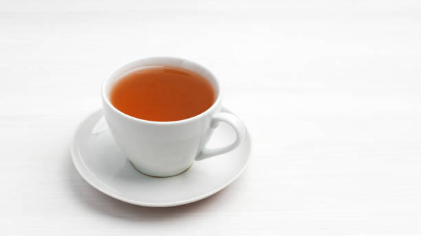 istock White cup of tea on a white wooden table. Copyspace. 1272066116