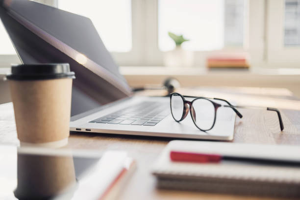 istock Place of work. Laptop and coffee at office desk 1272066854