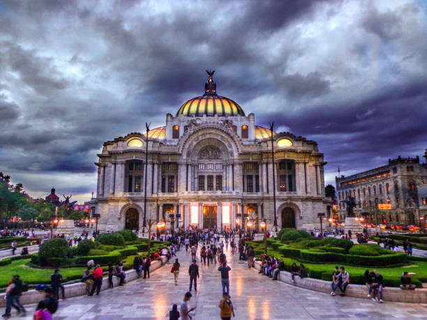 Palacio de Bellas Artes: Grand Entrance and Gardens of Historic Performing Arts Center in Mexico City under dramatic, dark sky - Mexico City, Mexico