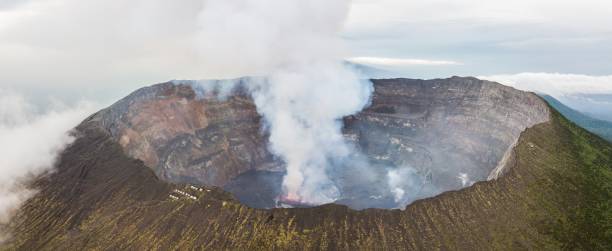 Panoramic view of active Nyiragongo volcano with lava lake emitting smoke