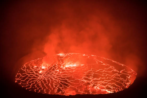 Beautifully structured glowing lava lake inside active Nyiragongo volcano emitting smoke