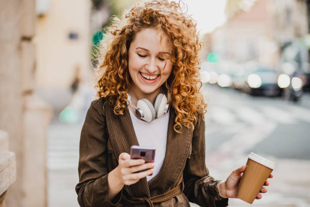 istock A young woman is using mobile phone on the move 1272073958