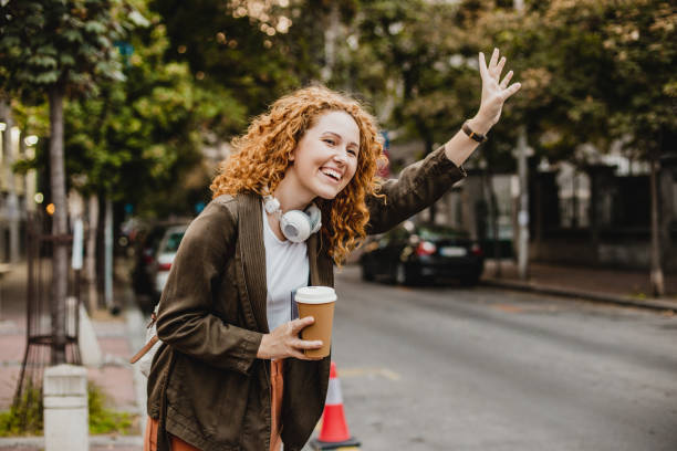 istock A young redhead woman is calling taxi 1272074044