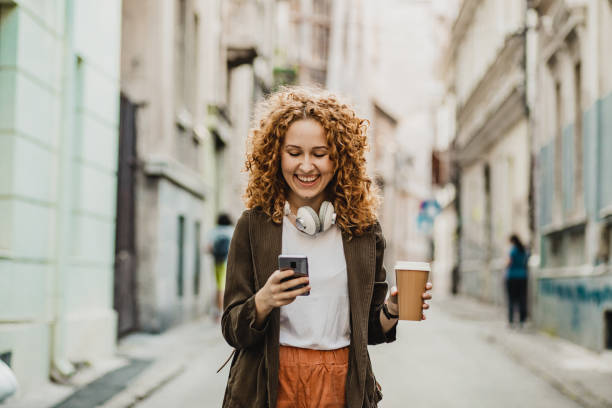 istock A young woman is using mobile phone on the move 1272074057
