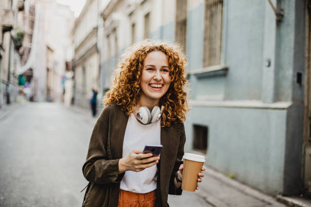 istock A young woman is using mobile phone on the move 1272074059