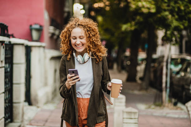istock A young woman is using mobile phone on the move 1272074145