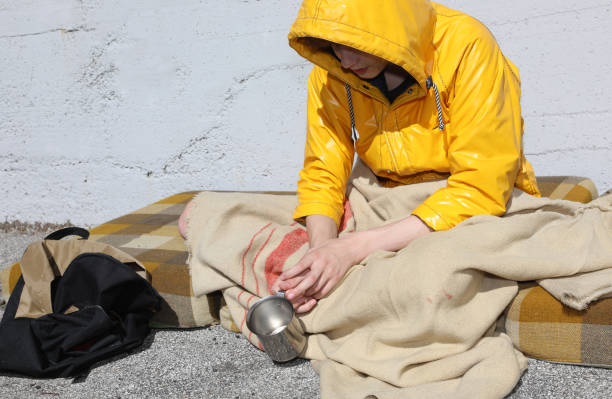 istock young homeless people begging passersby 1272074235