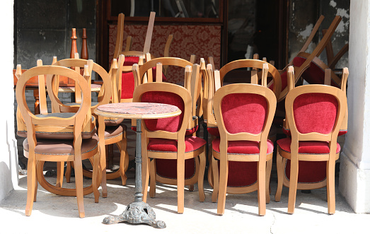 many chairs and tables outside the closed bar during the financial crisis caused by the coronavirus