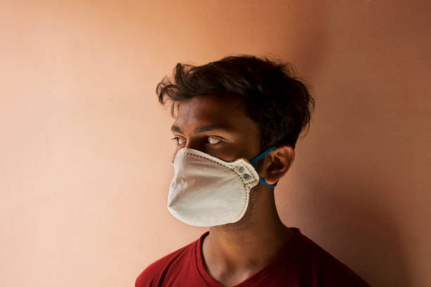 istock Indian Young Boy covering her face with pollution mask for protection from viruses 1272077341