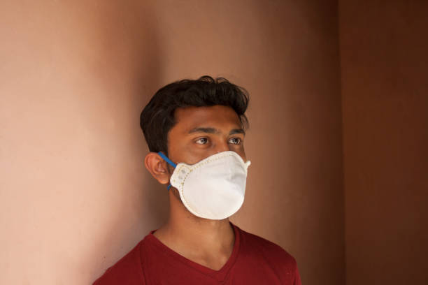 istock Indian Young Boy covering her face with pollution mask for protection from viruses 1272077349