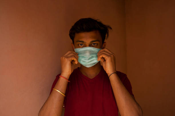 istock Indian Young Boy covering her face with pollution mask for protection from viruses 1272077417