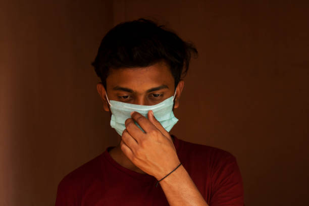 istock Indian Young Boy covering her face with pollution mask for protection from viruses 1272077427