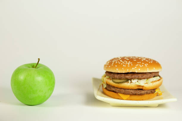 A man is seen holding a hamburger.