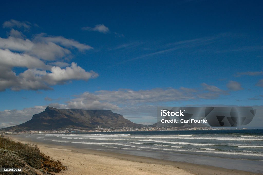 An image of Table Mountain in Cape Town taken from Milnerton Beach. Beach Stock Photo