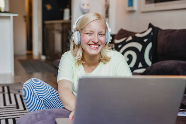 istock A young woman is watching something on a laptop at home 1272083352