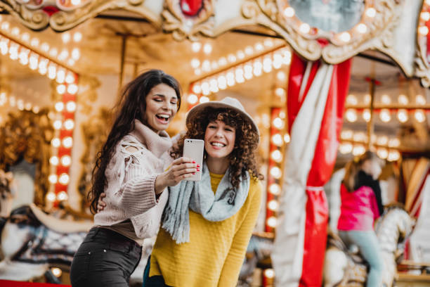 istock Two female friends having fun in amusement park 1272087240