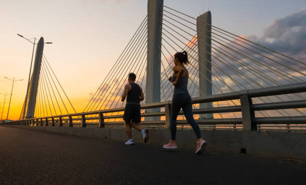 istock Young couple running together in morning 1272087581